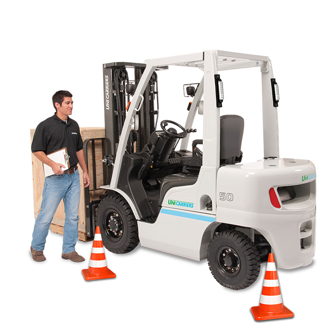 A student inspecting a forklift while holding a clipboard on a white background as part of his forklift safety training