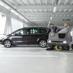 Thumbnail of http://A%20Worker%20Operating%20a%20Karcher%20B300%20Sweeper%20Scrubber%20Inside%20a%20Parking%20Garage%20Next%20to%20a%20Parked%20Car