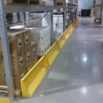 Thumbnail of http://Yellow%20Floor%20Mounted%20Barriers%20Installed%20Inside%20of%20a%20Warehouse%20In%20Front%20of%20a%20Pallet%20Rack