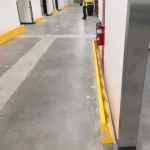 Thumbnail of http://Yellow%20Floor%20Mounted%20Barriers%20Installed%20Inside%20of%20a%20Warehouse%20In%20Front%20of%20a%20Wall