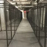 Thumbnail of http://A%20row%20of%20empty%20warehouse%20cages%20in%20a%20warehouse