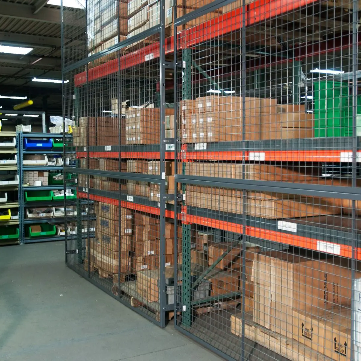 Rackback pallet rack safety panels installed on a row of pallet racking inside of a warehouse