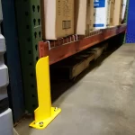 Thumbnail of http://A%20Closeup%20View%20of%20a%20Yellow%20Shallow%20Profile%20Column%20Guard%20Installed%20on%20a%20Pallet%20Racking%20Upright%20Inside%20of%20a%20Warehouse