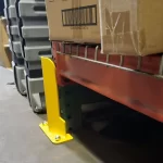 Thumbnail of http://A%20Closeup%20View%20of%20a%20Yellow%20Shallow%20Profile%20Column%20Guard%20Installed%20on%20a%20Pallet%20Racking%20Upright%20Inside%20of%20a%20Warehouse