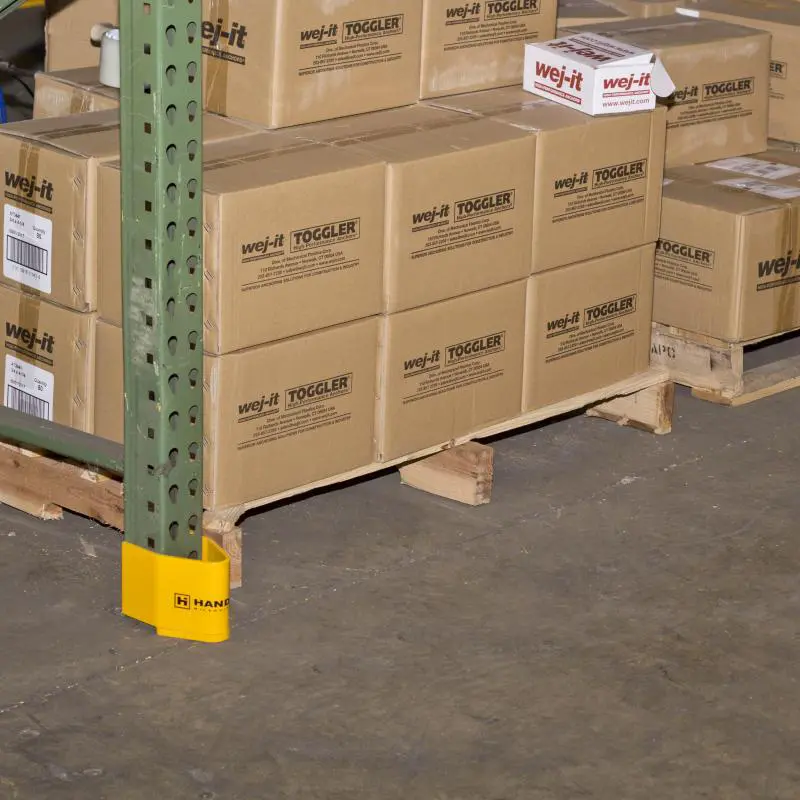 A Closeup View of a Yellow V-Nose Pallet Racking Protector on a Pallet Rack Inside of a Warehouse