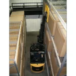 Thumbnail of http://a%20bendi%20forklift%20picking%20a%20pallet%20at%2090%20degrees%20inside%20of%20a%20narrow%20aisle