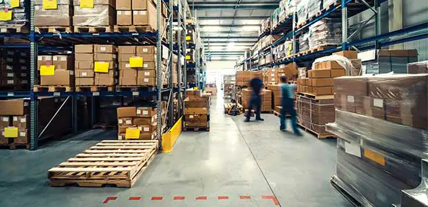 workers standing inside of a warehouse